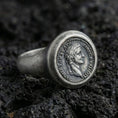 Load image into Gallery viewer, Sterling silver Roman coin signet ring with an oxidized finish, ancient emperor profile medallion with Latin-style lettering, macro on black volcanic rock

