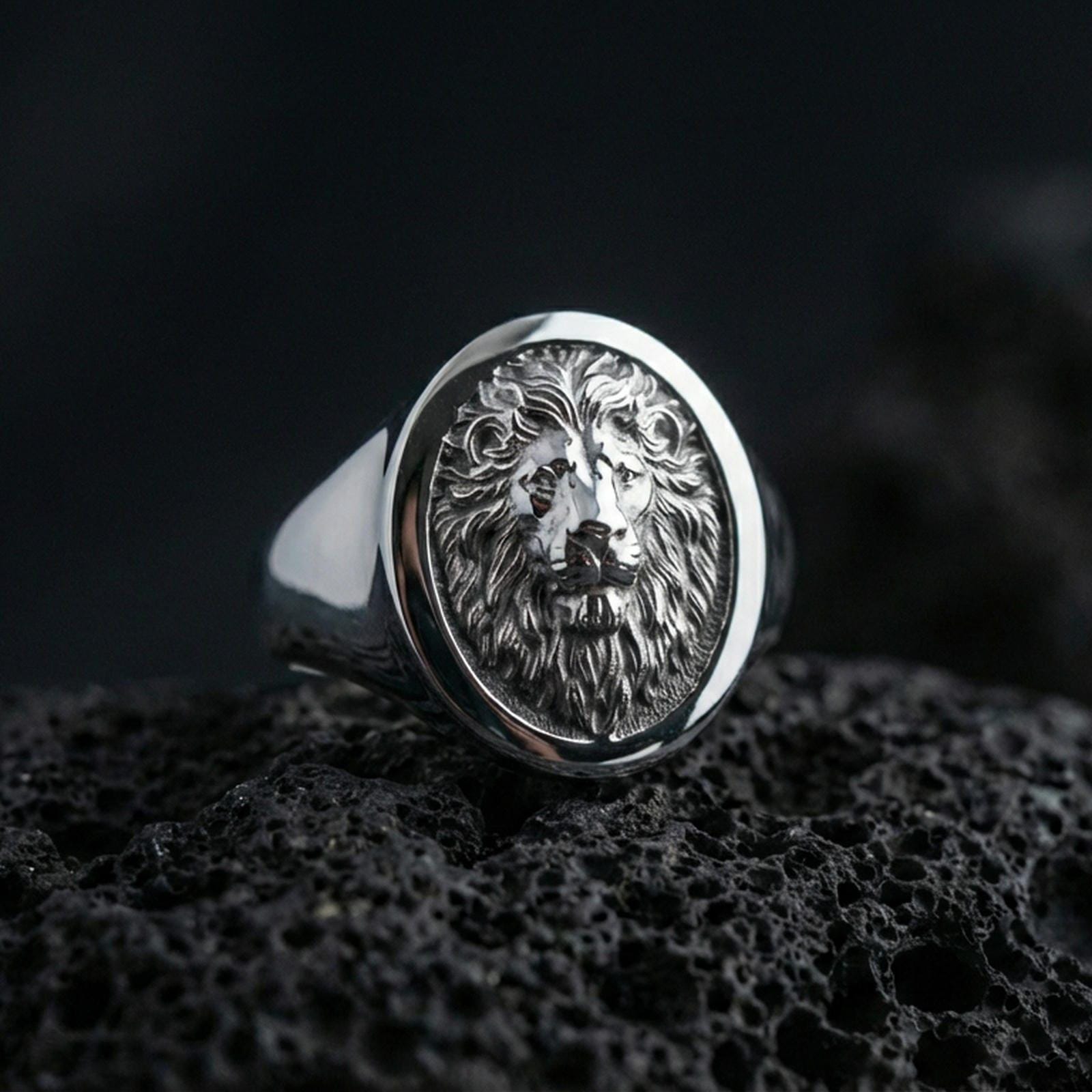 925 sterling silver lion head signet ring on volcanic stone, polished silver finish with crisp round face and textured background