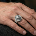 Load image into Gallery viewer, 925 sterling silver lion head signet ring worn on a finger, oxidized finish showing strong depth and shadowed engraving
