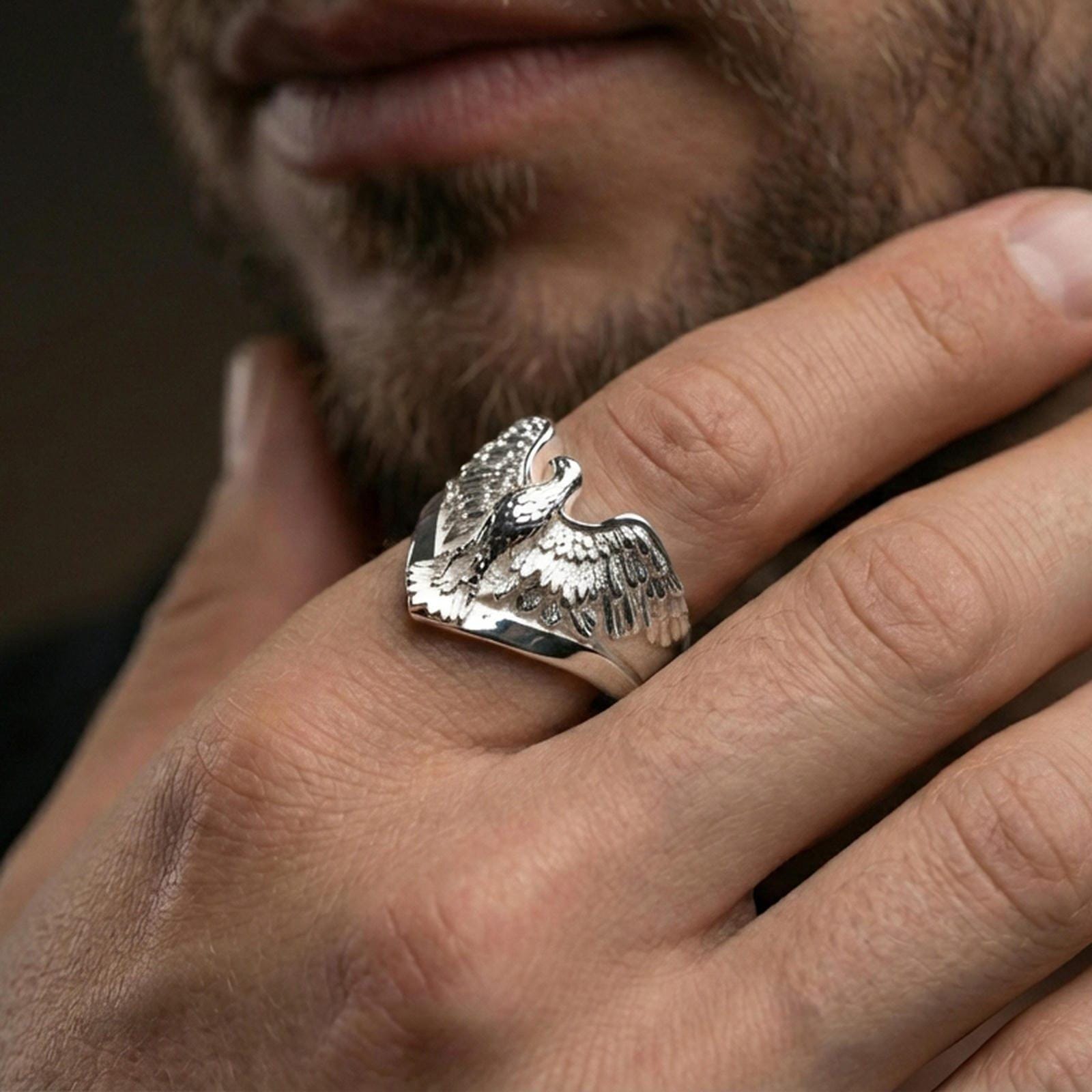 925 sterling silver eagle ring worn on a finger, polished silver finish with sharp highlights and defined wing engraving