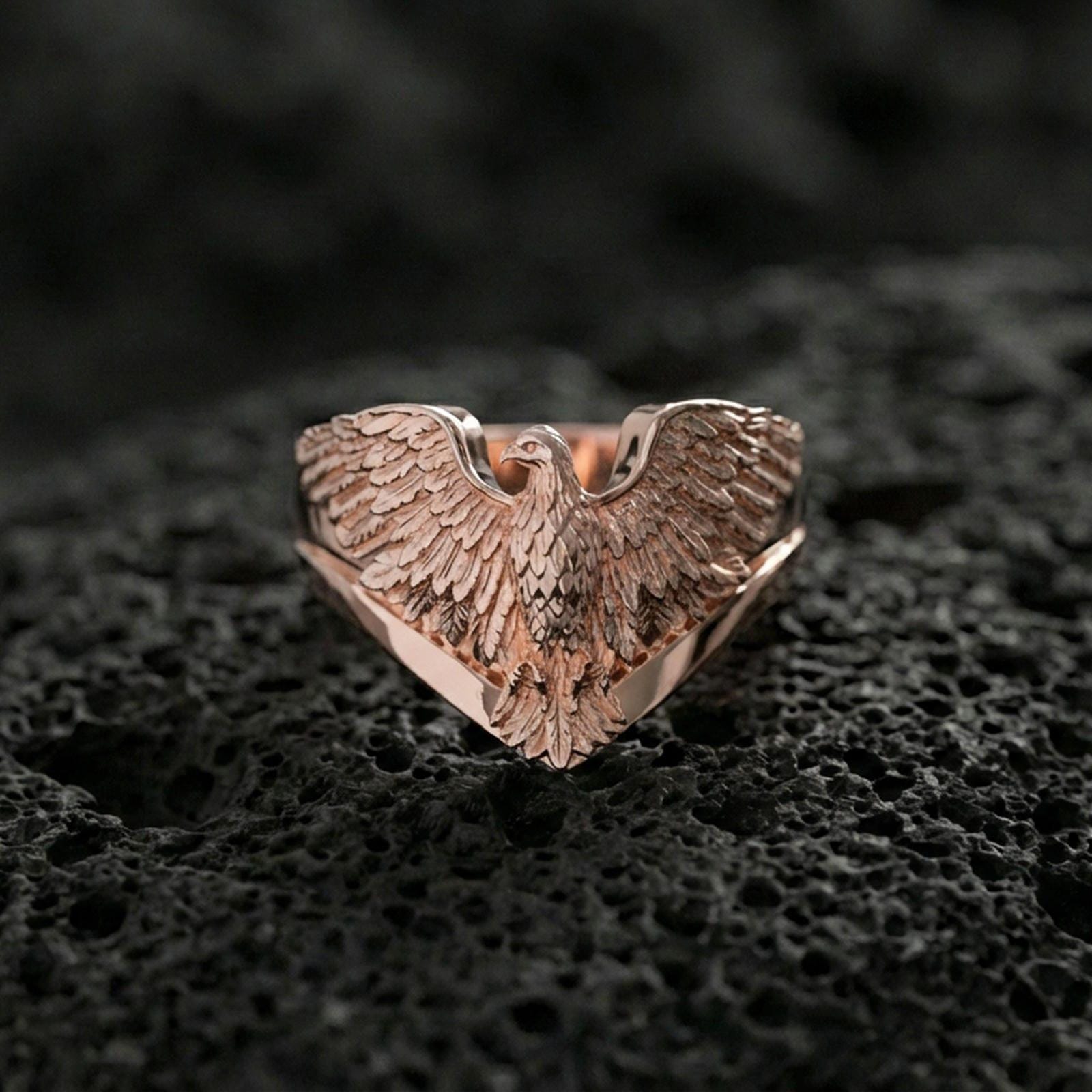 925 sterling silver eagle ring on volcanic stone, rose gold plated finish with warm tone and detailed feather relief across the wings