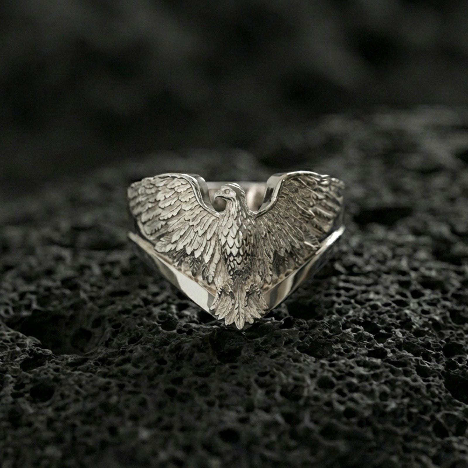 925 sterling silver eagle ring on volcanic stone, polished silver finish with crisp wing details and a clean V-shaped band profile