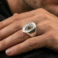 Load image into Gallery viewer, Polished silver bull ring on finger, natural hand pose highlighting the sculpted horns and strong masculine silhouette

