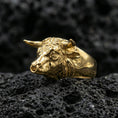 Load image into Gallery viewer, Gold plated bull head ring on porous volcanic stone, premium studio shot emphasizing the horned animal head and bold silhouette
