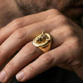 Load image into Gallery viewer, Gold plated bull signet ring worn on finger, lifestyle wear shot emphasizing the bold horned portrait and strong statement look
