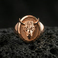 Load image into Gallery viewer, Rose gold plated bull head signet ring on volcanic rock, sharp macro product photo showcasing the oval top and detailed relief
