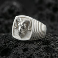 Load image into Gallery viewer, Polished silver ram head ring on volcanic stone, detailed horns and textured background
