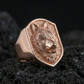Load image into Gallery viewer, Rose gold plated wolf head signet ring on volcanic rock, textured background and sculpted detail
