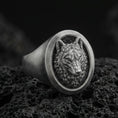 Load image into Gallery viewer, Oxidized sterling silver wolf signet ring on volcanic rock, macro closeup with dark textured backdrop
