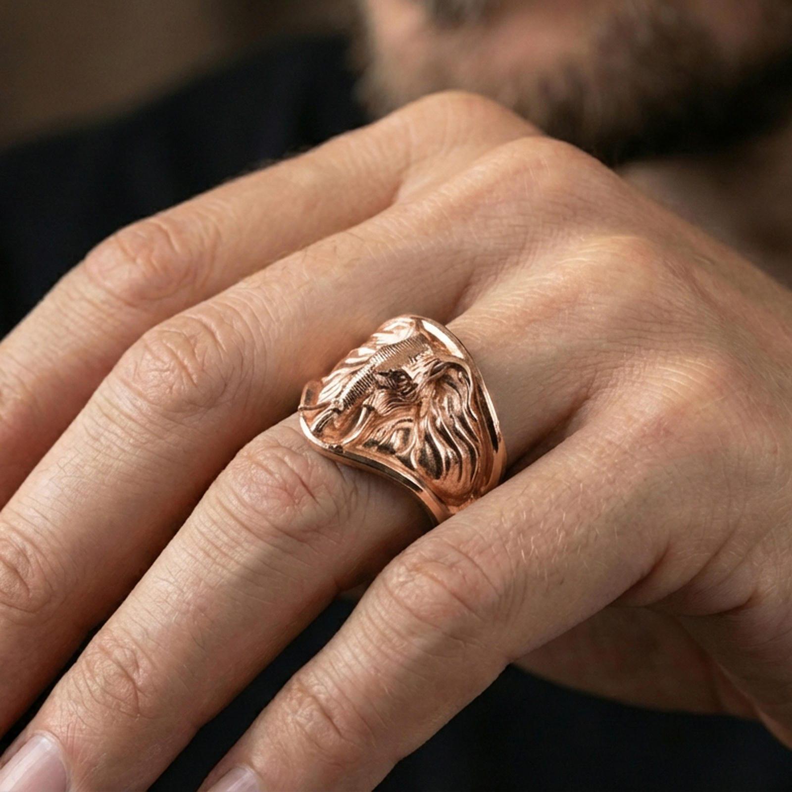Rose gold plated elephant head ring on finger, close-up lifestyle photo showcasing the detailed ears, tusks, and wide signet silhouette