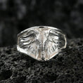 Load image into Gallery viewer, Polished silver elephant head signet ring on volcanic rock surface, close-up highlighting the wide geometric face, sculpted trunk, and crisp bezel edges
