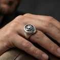 Load image into Gallery viewer, Oxidized elephant signet ring worn on finger, lifestyle close-up focusing on the oval face and frontal elephant head relief with tusks
