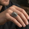 Load image into Gallery viewer, Oxidized lion head ring worn on finger, lifestyle close-up focusing on the roaring face, sculpted fangs, and detailed mane texture
