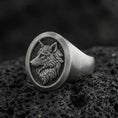 Load image into Gallery viewer, Oxidized sterling silver wolf signet ring on volcanic rock, macro closeup with deep shadow contrast
