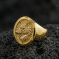 Load image into Gallery viewer, Gold plated wolf head ring on volcanic stone, bold animal emblem with crisp sculpted fur texture
