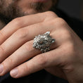 Load image into Gallery viewer, Oxidized sterling silver wolf ring worn on a finger, showing the sculpted wolf face and detailed fur texture
