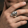 Load image into Gallery viewer, Polished silver gorilla head ring on a hand, close-up emphasizing the open mouth and carved fur texture
