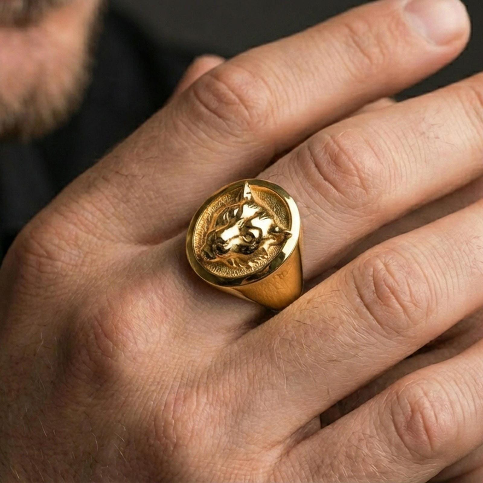 Gold plated leopard signet ring worn on finger, lifestyle wear shot emphasizing the bold big cat design and statement look