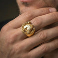Load image into Gallery viewer, Gold plated horseshoe horse ring worn on finger, lifestyle wear shot emphasizing the bold equestrian motif and statement look
