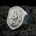 Load image into Gallery viewer, Polished silver lion signet ring on textured volcanic stone with sharp macro detail and soft directional lighting
