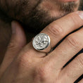 Load image into Gallery viewer, Polished silver heraldic lion signet ring on finger, natural hand pose highlighting the lion emblem engraving and classic signet profile
