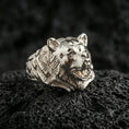 Load image into Gallery viewer, Polished silver bear ring on textured volcanic stone, macro focus on the carved fur and defined facial contours
