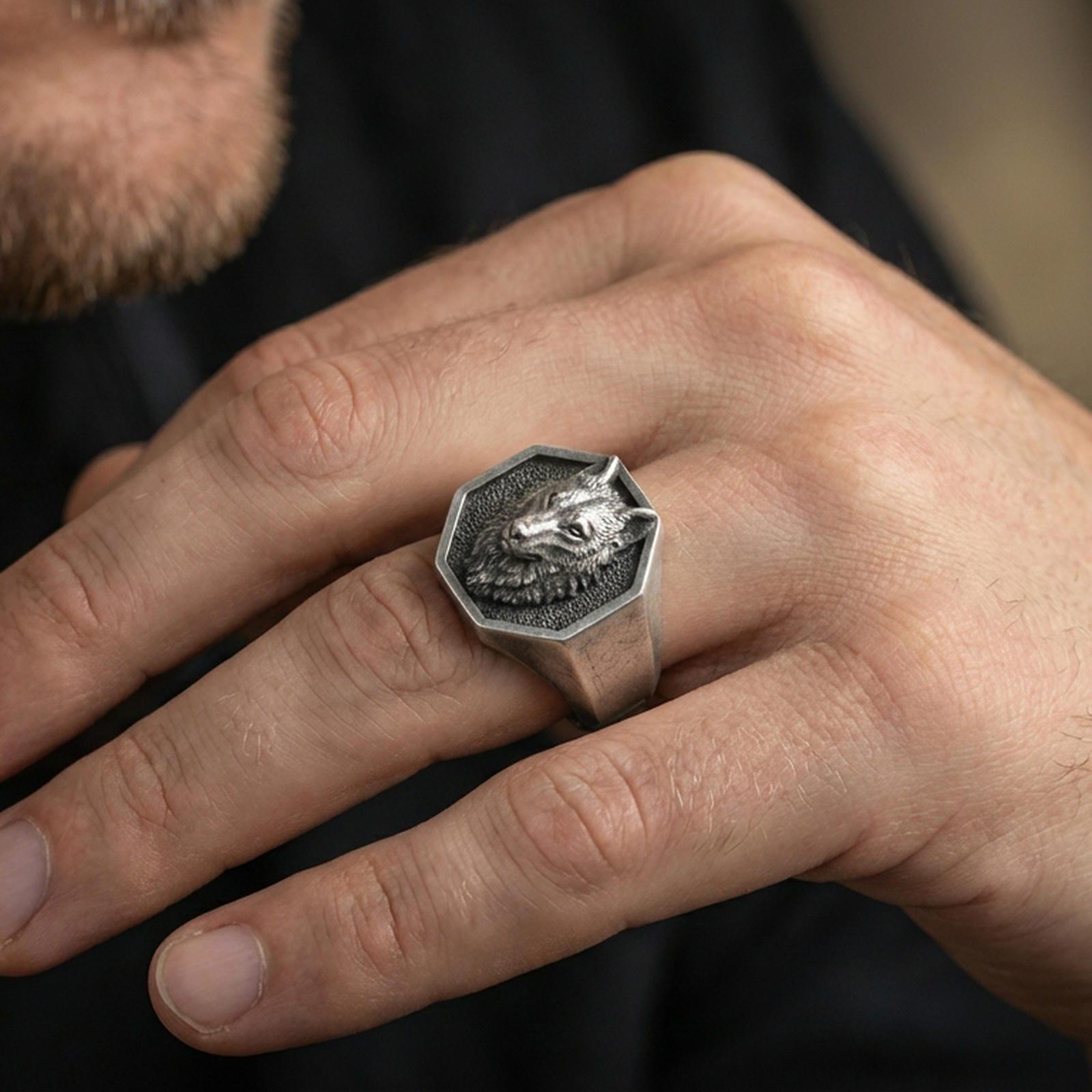 Oxidized sterling silver octagon wolf ring worn on a finger, angled view showing the geometric face and profile