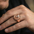 Load image into Gallery viewer, Rose gold plated wolf head signet ring worn on a finger, macro focus on the facial details and texture contrast
