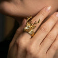 Load image into Gallery viewer, Gold plated deer antler ring worn on a finger against a dark minimal background, bold statement styling
