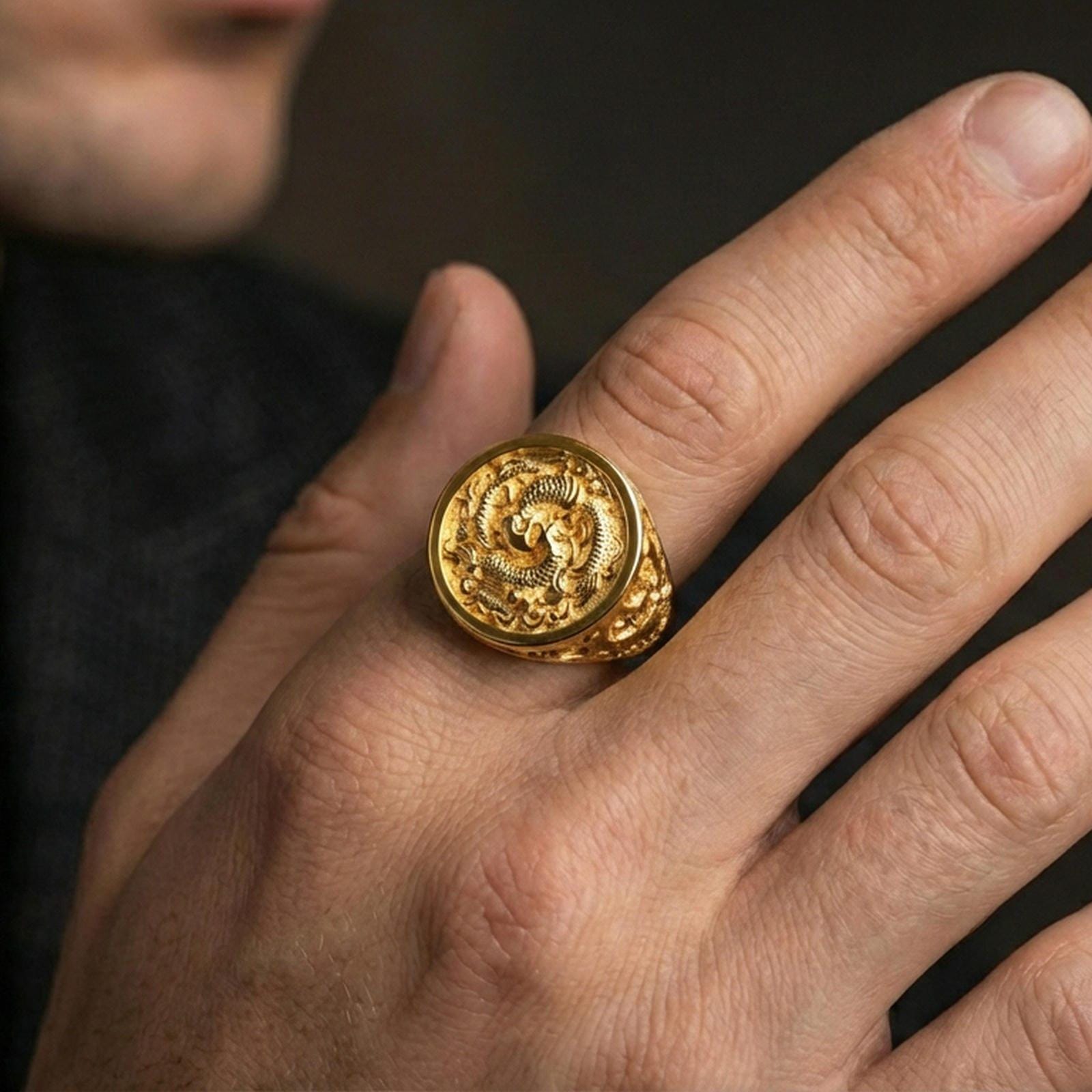 Gold plated koi fish ring worn on a finger against a dark background, premium statement styling