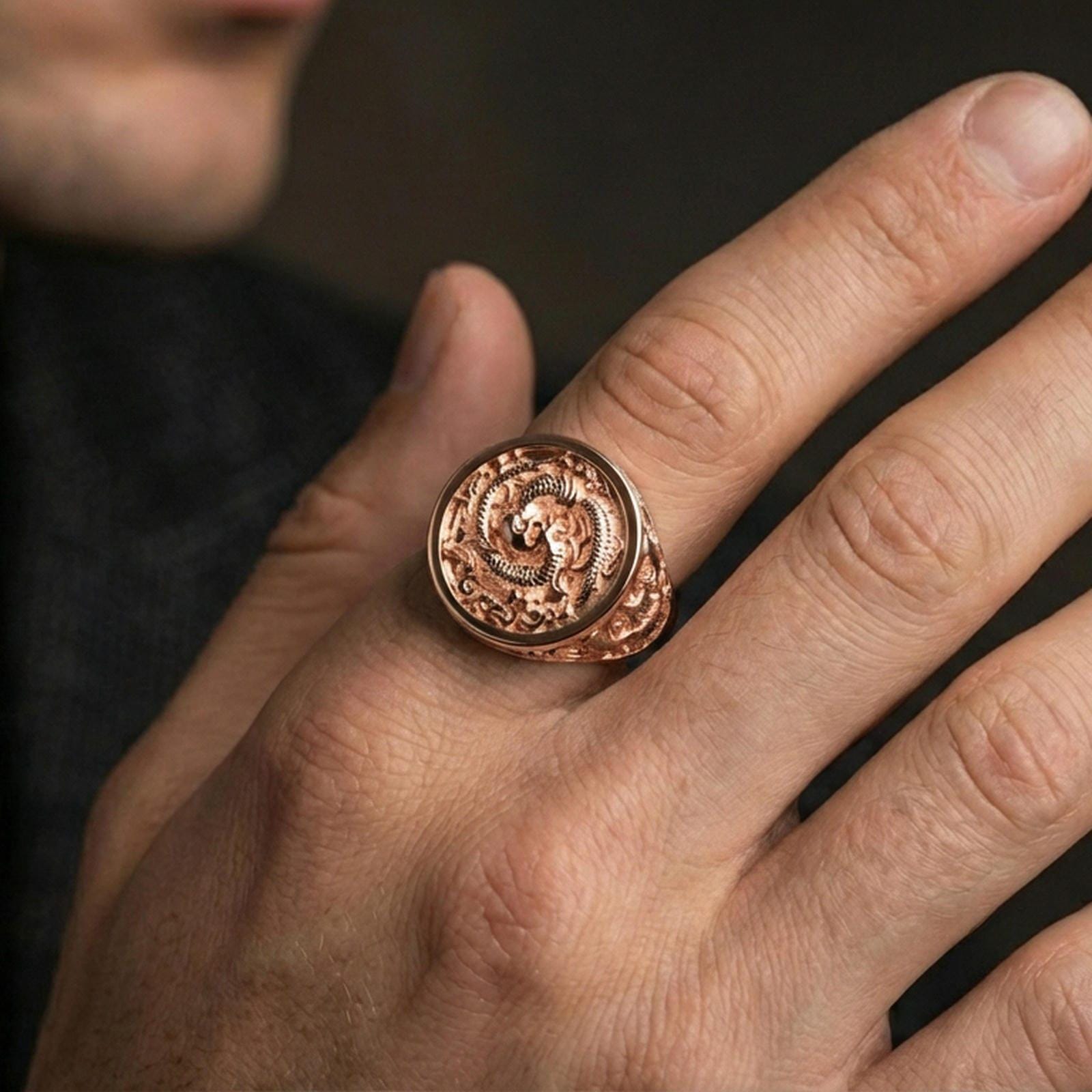 Rose gold plated yin yang koi ring worn on a finger, macro shot focused on the koi fish and texture