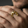 Load image into Gallery viewer, Gold plated finish sterling silver shattered skull ring worn on a finger, close-up lifestyle photo emphasizing the edgy skull details and distressed carved surfaces
