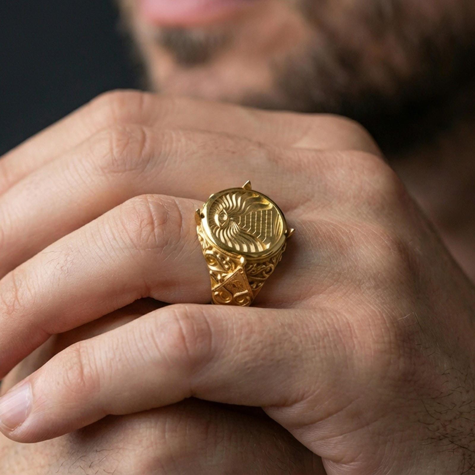 Sterling silver illuminati-style ring worn on a finger, close-up lifestyle photo showcasing the gold plated finish and detailed round signet face