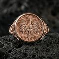 Load image into Gallery viewer, Sterling silver phoenix statement ring with a rose gold plated finish, round engraved mythical bird motif and intricate ornamental background, close-up on volcanic rock
