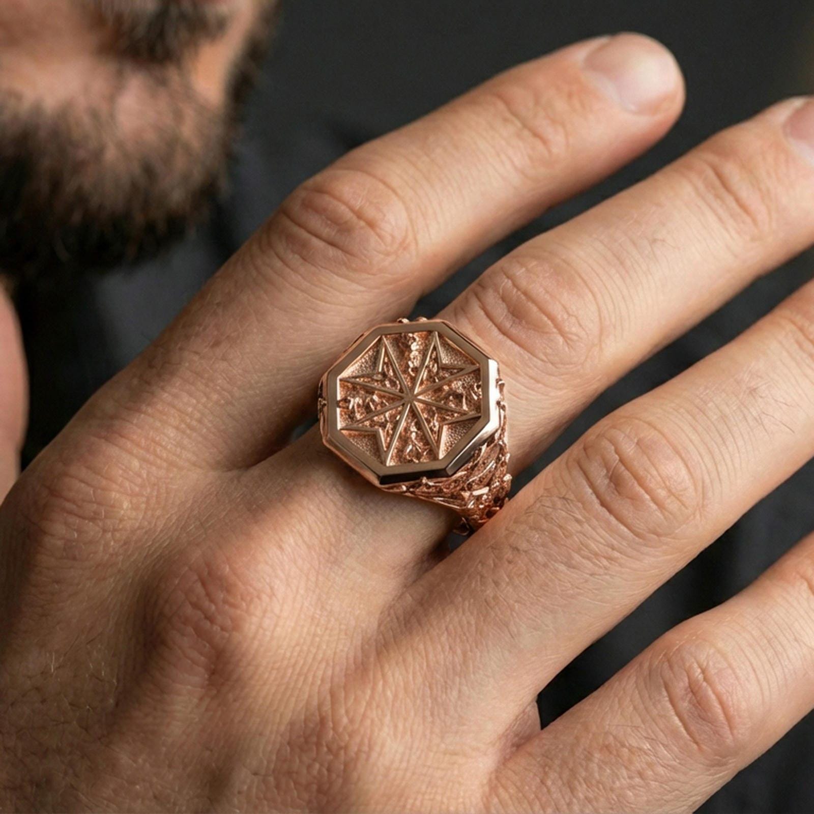 Sterling silver Templar-style Maltese cross ring on a finger, macro lifestyle shot featuring the rose gold plated finish and textured octagonal signet face