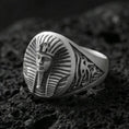 Load image into Gallery viewer, Sterling silver Egyptian pharaoh signet ring with an oxidized finish, oval face featuring a detailed royal pharaoh portrait and engraved side motifs, macro on black volcanic rock
