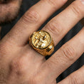 Load image into Gallery viewer, Sterling silver Spartan warrior ring worn on a finger, close-up lifestyle photo showcasing the gold plated finish and bold round signet profile
