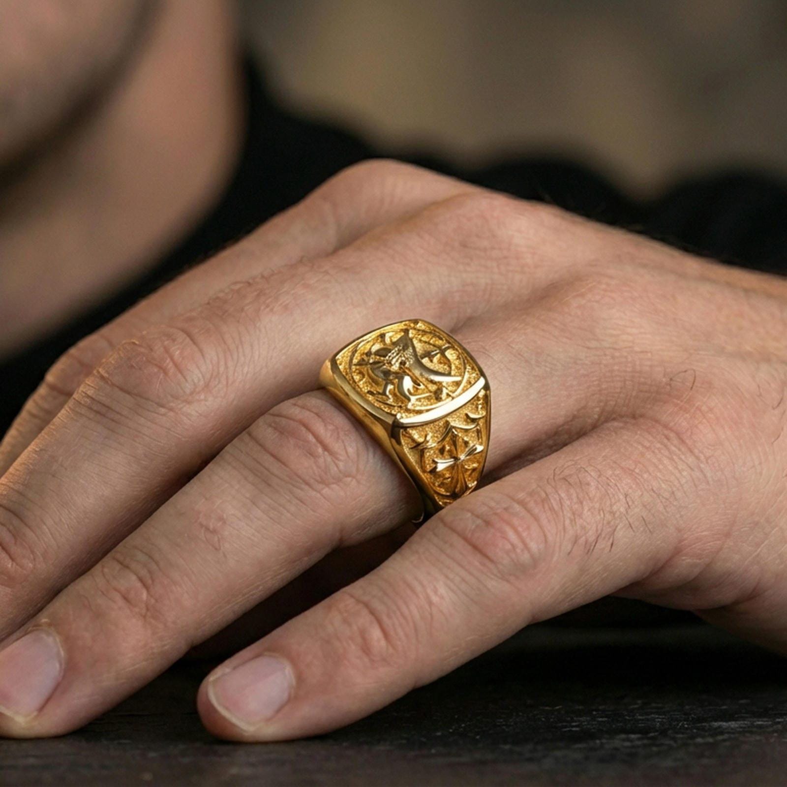 Sterling silver lion crest signet ring worn on a finger, close-up lifestyle photo showcasing the gold plated finish and raised cross-and-lion emblem