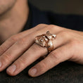 Load image into Gallery viewer, Sterling silver samurai mask statement ring on a finger, macro lifestyle shot featuring the rose gold plated finish and bold Japanese warrior motif
