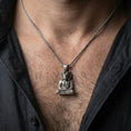 Load image into Gallery viewer, Sterling silver Khnum pendant necklace worn on the neck, close-up lifestyle shot showing the oxidized finish and ram-headed Egyptian deity meditation design
