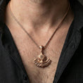 Load image into Gallery viewer, Sterling silver Viking axe pendant necklace on the neck, macro lifestyle shot showcasing the rose gold plated finish and runic compass centerpiece
