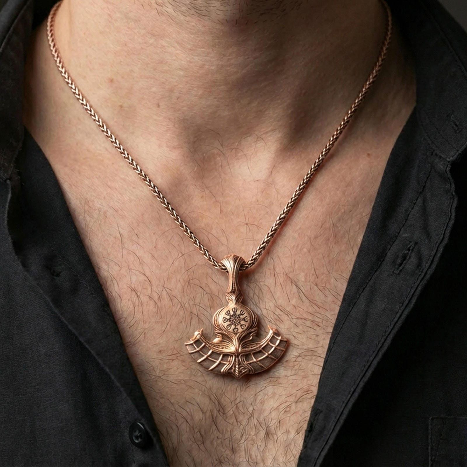 Sterling silver Viking axe pendant necklace on the neck, macro lifestyle shot showcasing the rose gold plated finish and runic compass centerpiece