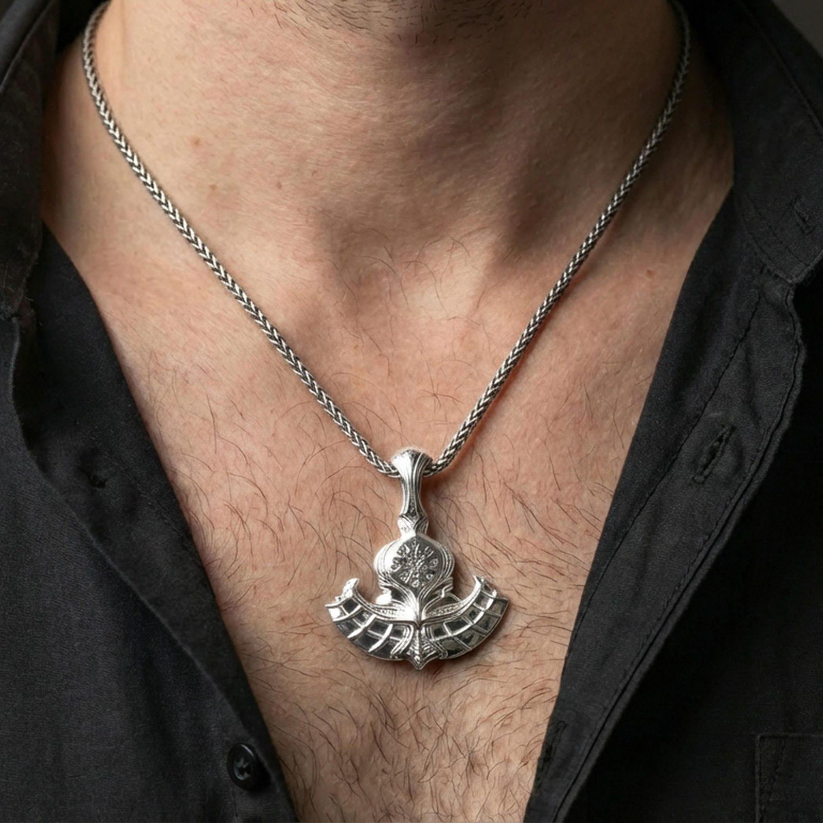 Sterling silver Norse battle axe necklace on the neck, macro lifestyle image showing the polished silver finish and engraved Vegvisir emblem