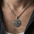 Load image into Gallery viewer, Sterling silver dragon medallion pendant necklace worn on the neck, close-up lifestyle shot highlighting the oxidized finish and sculpted dragon relief
