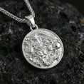 Load image into Gallery viewer, Sterling silver circular dragon pendant in a polished silver finish, high-relief Asian dragon design with textured scales, macro product shot on volcanic stone
