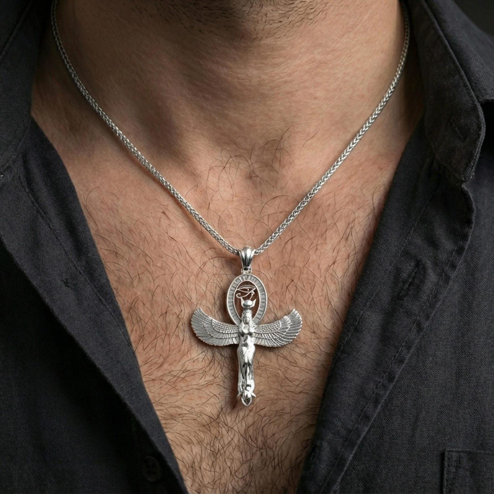 Sterling silver winged Isis pendant necklace on the neck, macro lifestyle image showing the polished silver finish and Egyptian goddess relief