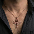 Load image into Gallery viewer, Sterling silver winged Isis pendant necklace on the neck, macro lifestyle shot showcasing the rose gold plated finish and oval halo motif
