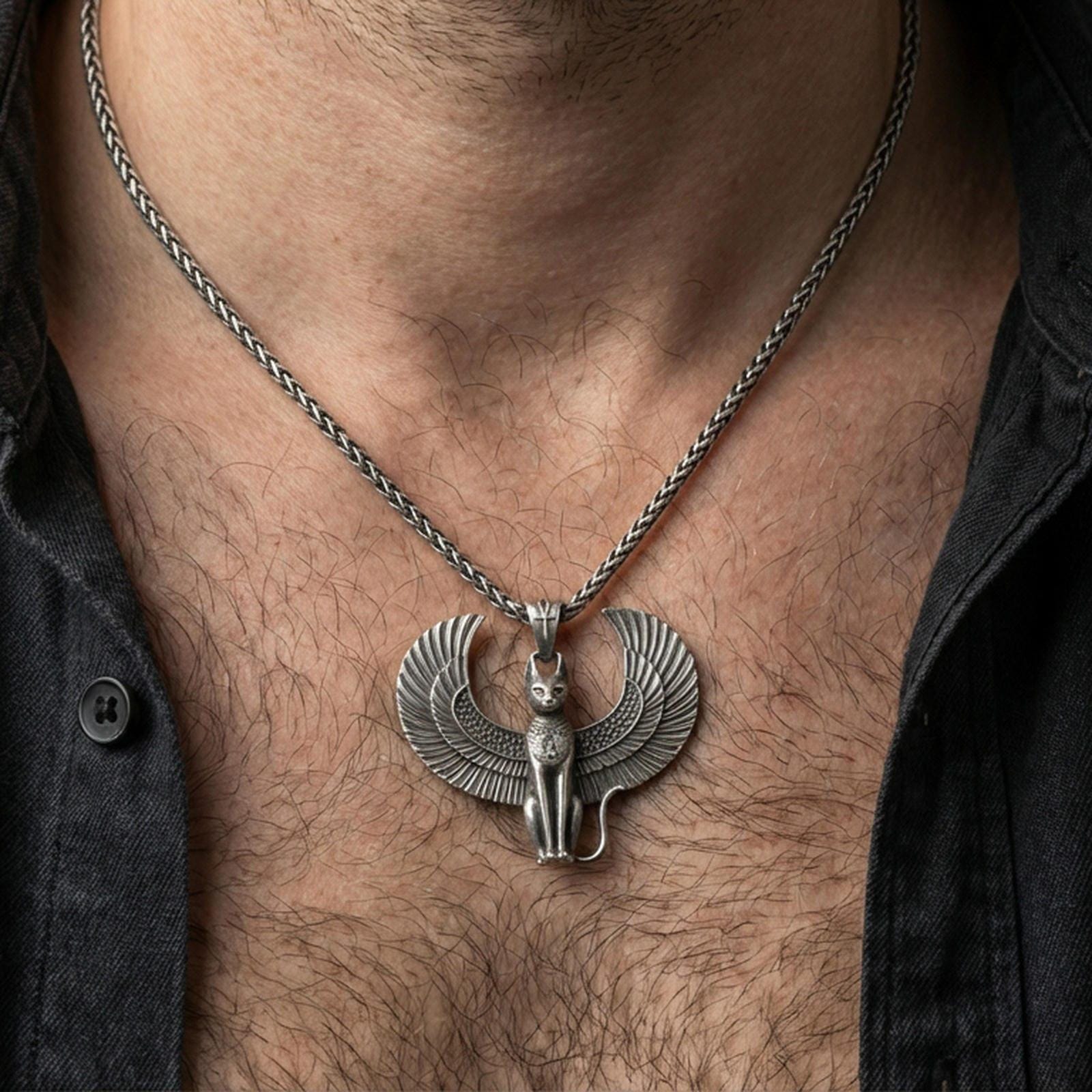Sterling silver winged Bastet cat pendant necklace worn on the neck, close-up lifestyle shot highlighting the oxidized finish and feather wing details