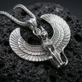 Load image into Gallery viewer, Sterling silver winged Bastet cat pendant in a polished silver finish, crisp feathered wings and sculpted cat face, macro on volcanic stone
