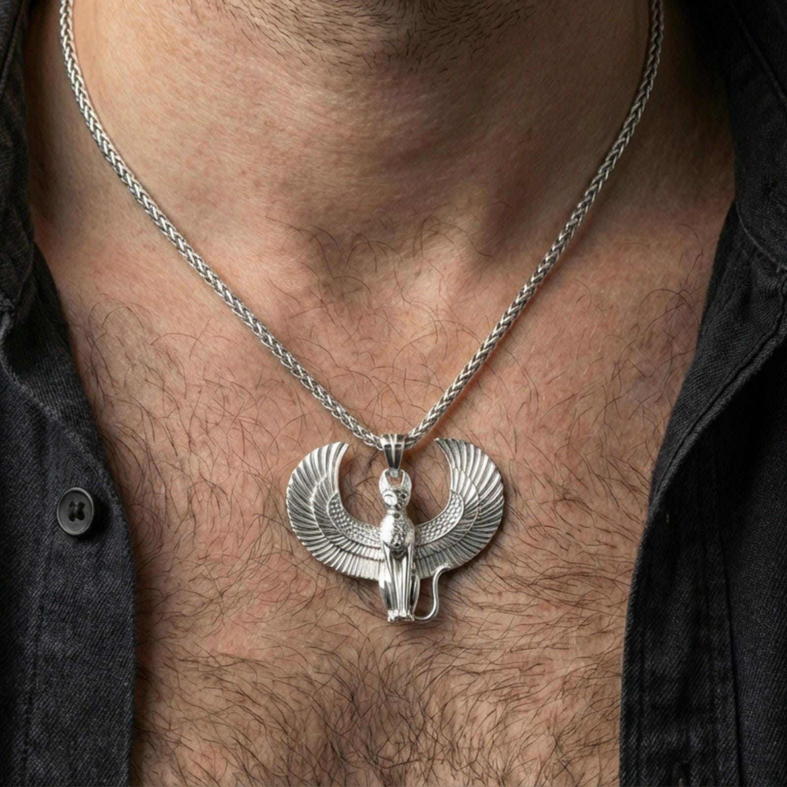 Sterling silver winged Egyptian cat pendant necklace on the neck, macro lifestyle image showing the polished silver finish and sculpted feline features